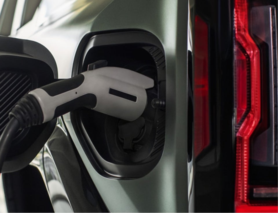 Close up of charging port with charger plugged in on a GMC Hummer EV SUV - Alfred Matthews GMC in Modesto CA