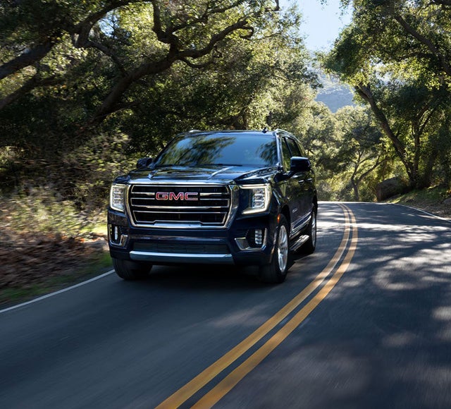 2024 GMC Yukon Driving Down a Scenic Road