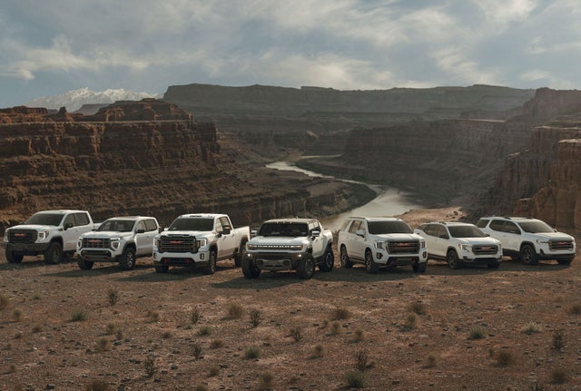 GMC Lineup of vehicles parked in front above a canyon river
